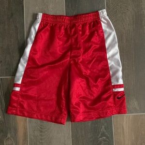 Red and white boys or girls basketball shorts. These shorts can be unisex.